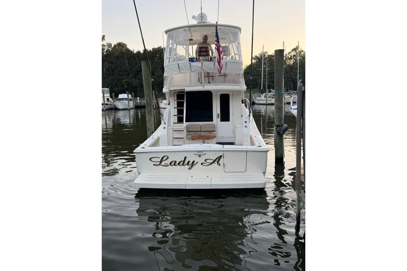 Slide: The Image of 2017 Tiara Yachts 39 Convertible docked, rear view with "Lady A" name visible. - 13