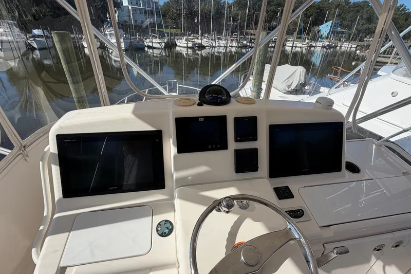 Slide: The Image of Helm of 2017 Tiara Yachts 39 Convertible with navigation screens and steering wheel. - 47