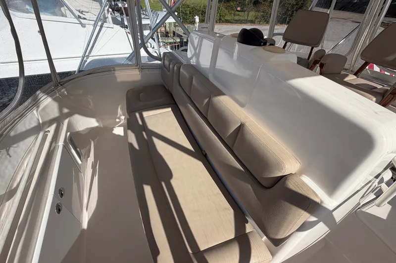 Slide: The Image of 2017 Tiara Yachts 39 Convertible interior with beige seating and helm station. - 36