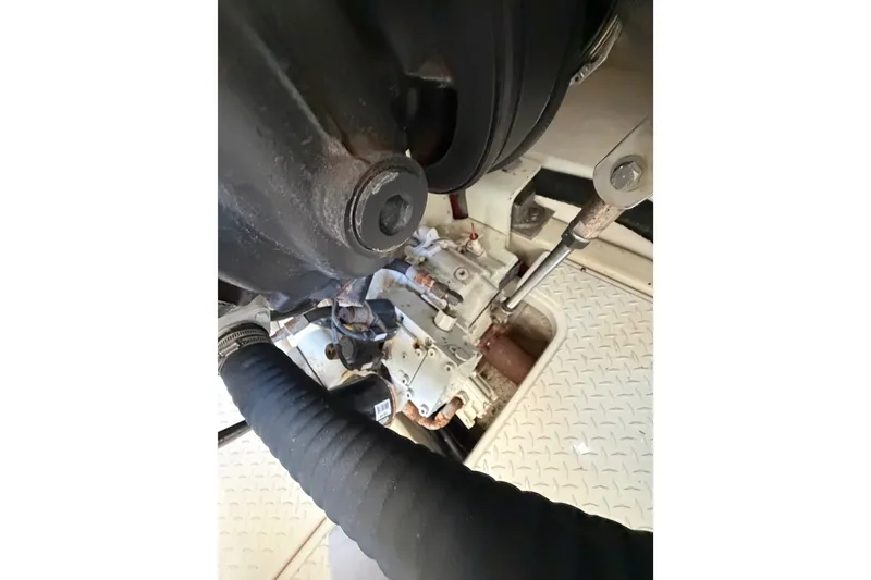 Slide: The Image of Engine compartment of 2017 Tiara Yachts 39 Convertible, showing mechanical components and hoses. - 27