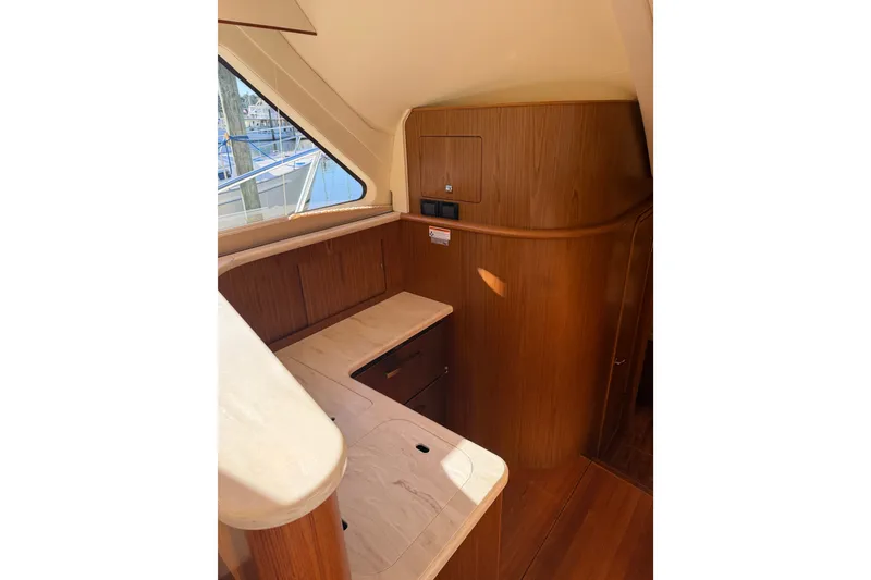 Slide: The Image of Interior of 2017 Tiara Yachts 39 Convertible, featuring elegant wood cabinetry and countertops. - 48