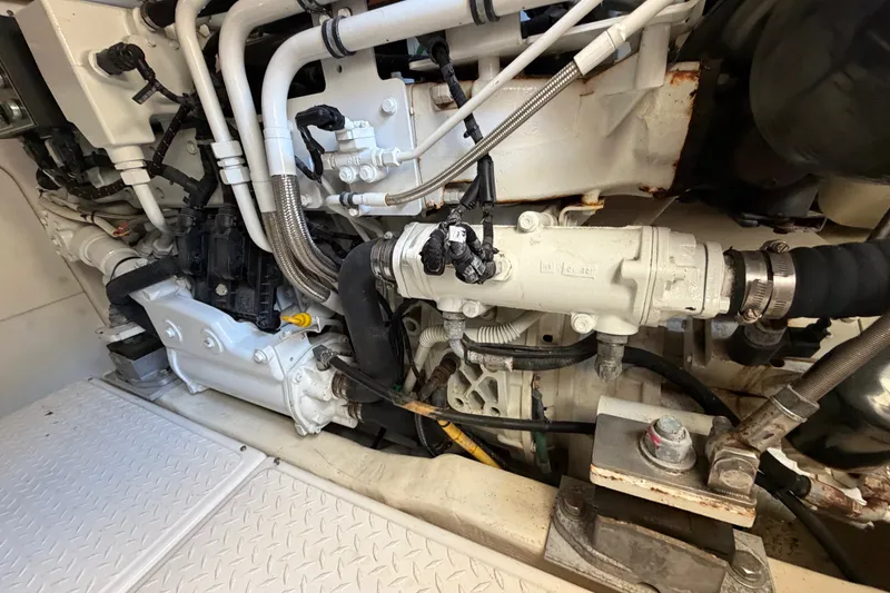 Slide: The Image of Engine compartment of a 2017 Tiara Yachts 39 Convertible, showcasing mechanical components and piping. - 24