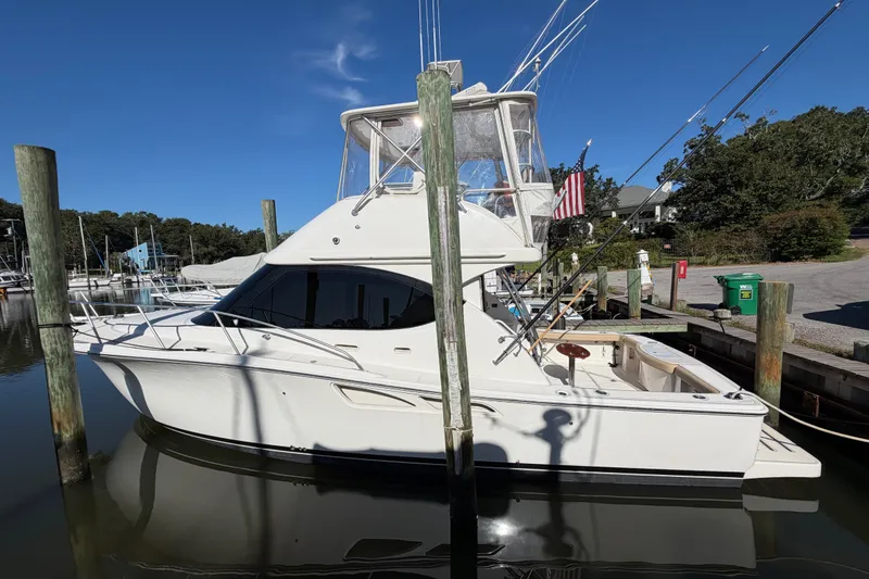 Slide: The Image of 2017 Tiara Yachts 39 Convertible docked at marina under clear blue sky. - 14