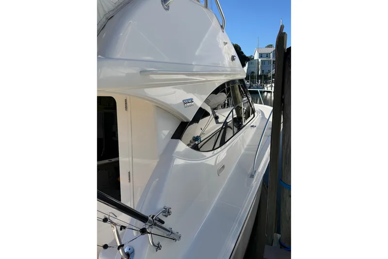 Slide: The Image of 2017 Tiara Yachts 39 Convertible docked, showcasing sleek design and modern features. - 18
