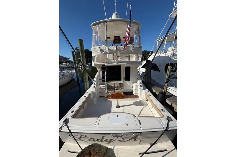 Slide: The Image of 2017 Tiara Yachts 39 Convertible docked, rear view with American flag. - 56