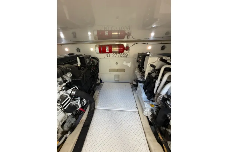 Slide: The Image of Engine room of 2017 Tiara Yachts 39 Convertible, featuring dual engines and fire extinguisher. - 29
