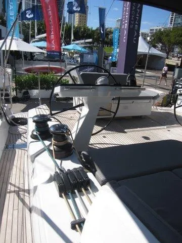 Slide: The Image of 2025 Jeanneau Yacht 65 deck with steering wheels and winches. - 22