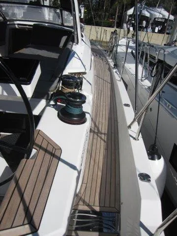 Slide: The Image of 2025 Jeanneau Yacht 65 deck with winches and seating area. - 17
