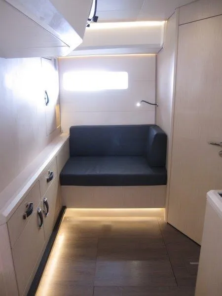 Slide: The Image of 2024 Jeanneau 60 yacht interior with modern seating and ambient lighting. - 40