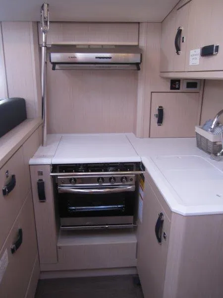 Slide: The Image of Modern kitchen in 2024 Jeanneau 60 yacht with stove and ample storage. - 17