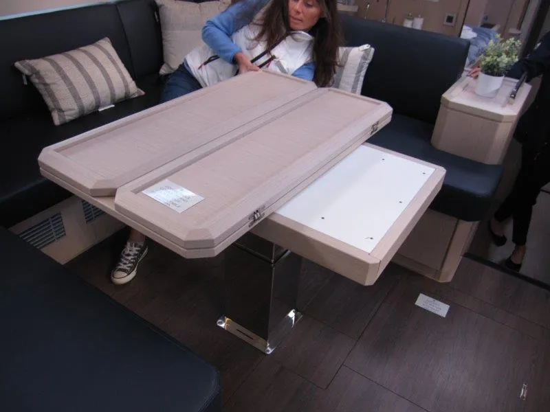 Slide: The Image of Interior of 2024 Jeanneau 60 yacht with convertible dining table and seating area. - 25