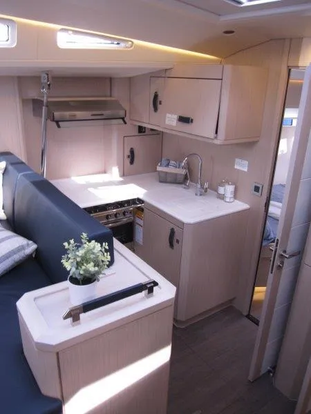 Slide: The Image of Modern kitchen area in 2024 Jeanneau 60 yacht with sleek cabinetry and compact design. - 11