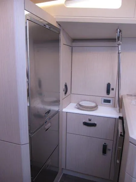 Slide: The Image of 2024 Jeanneau 60 yacht kitchen with modern appliances and sleek cabinetry. - 21