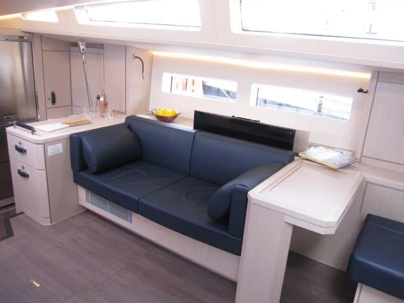 Slide: The Image of Modern interior of 2024 Jeanneau 60 yacht with blue sofa and dining area. - 5
