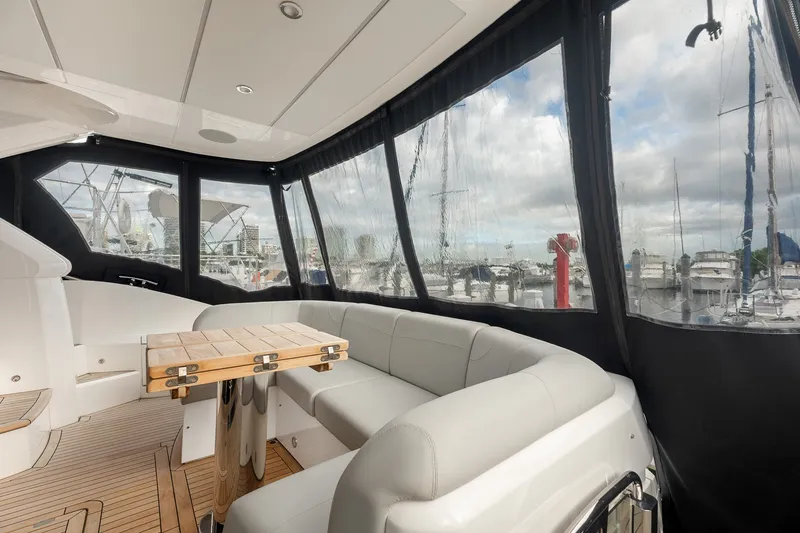 Slide: The Image of Luxurious interior of 2023 Sunseeker Manhattan 55 yacht with elegant seating and marina view. - 18
