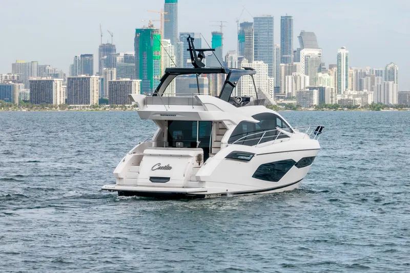 Slide: The Image of 2023 Sunseeker Manhattan 55 yacht cruising near city skyline. - 5