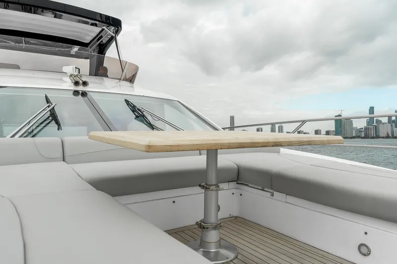 Slide: The Image of Luxurious Sunseeker Manhattan 55 yacht deck with seating and table, city skyline in background. - 38