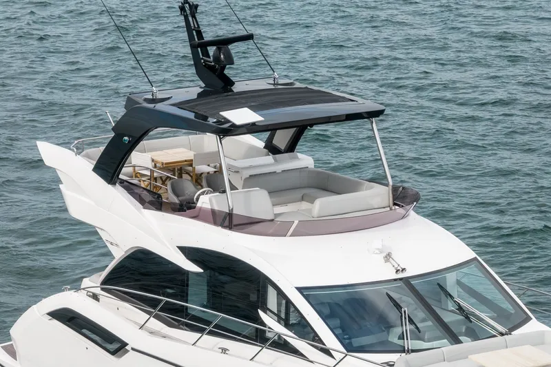 Slide: The Image of 2023 Sunseeker Manhattan 55 yacht on water, featuring sleek design and spacious deck. - 7