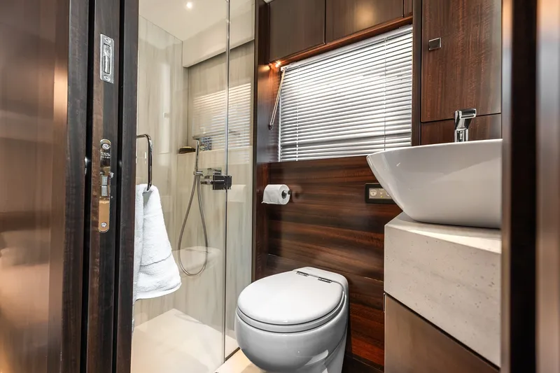 Slide: The Image of Luxurious bathroom in 2023 Sunseeker Manhattan 55 yacht, featuring modern fixtures and elegant wood finishes. - 49