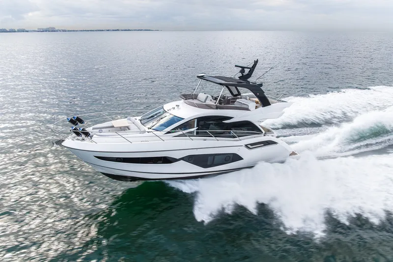 Slide: The Image of 2023 Sunseeker Manhattan 55 yacht cruising on open water, showcasing sleek design and luxury. - 2