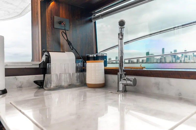 Slide: The Image of Luxurious kitchen area on 2023 Sunseeker Manhattan 55 yacht with city skyline view. - 30
