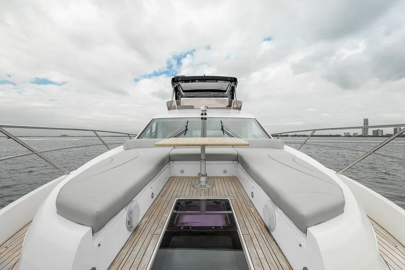 Slide: The Image of 2023 Sunseeker Manhattan 55 yacht deck with seating and table, ocean view. - 37
