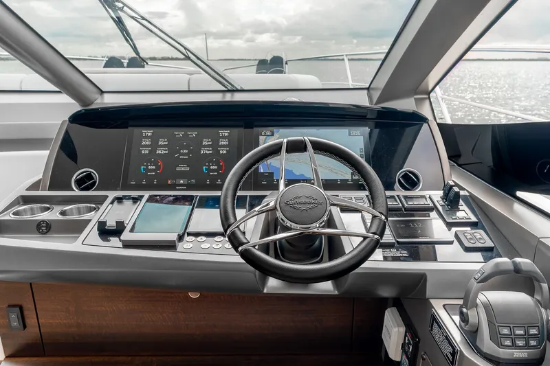 Slide: The Image of 2023 Sunseeker Manhattan 55 yacht helm with advanced navigation displays and controls. - 26
