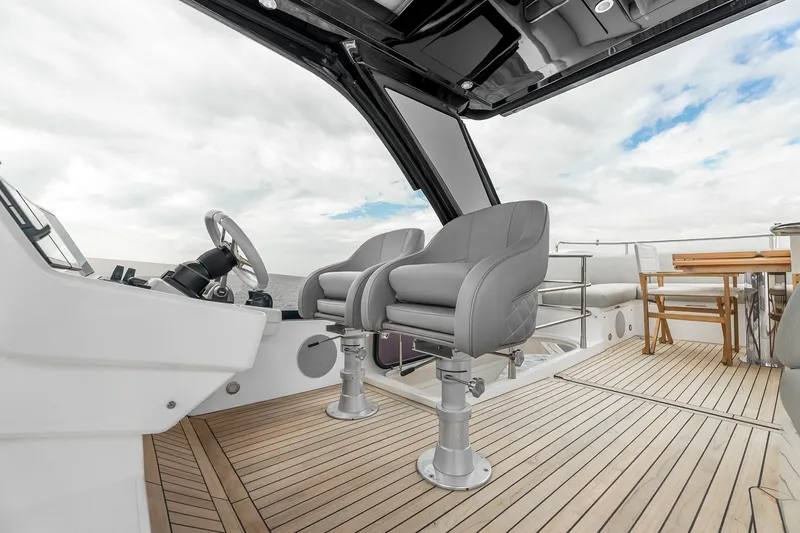 Slide: The Image of Luxury Sunseeker Manhattan 55 yacht cockpit with modern seating and wooden deck, 2023 model. - 42
