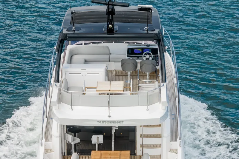 Slide: The Image of 2023 Sunseeker Manhattan 55 yacht cruising on open water, showcasing luxurious deck and seating. - 11