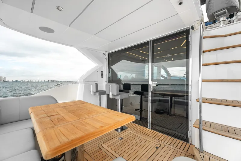 Slide: The Image of Luxurious 2023 Sunseeker Manhattan 55 yacht deck with seating, table, and ocean view. - 33