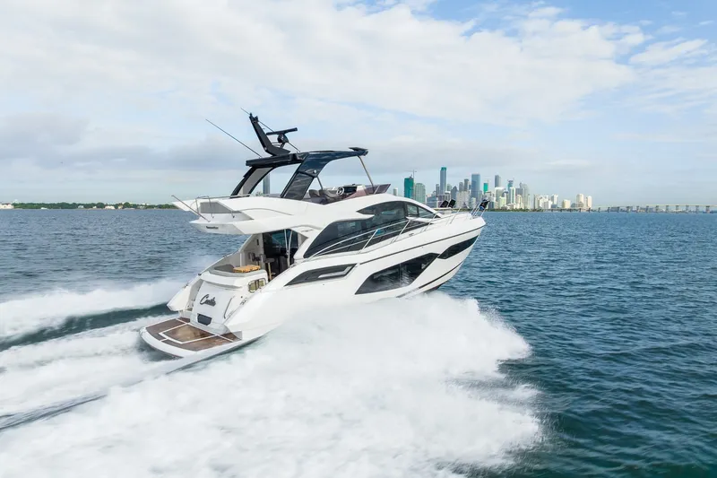The Image of 2023 Sunseeker Manhattan 55 yacht cruising near city skyline on a sunny day. - 4