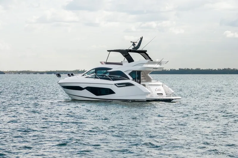 Slide: The Image of 2023 Sunseeker Manhattan 55 yacht cruising on open water. - 9