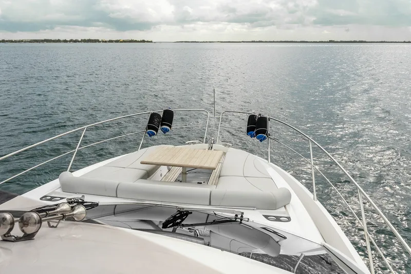 Slide: The Image of 2023 Sunseeker Manhattan 55 yacht bow view on open water under cloudy sky. - 46