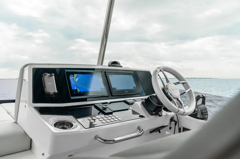 Slide: The Image of 2023 Sunseeker Manhattan 55 yacht helm with modern navigation displays and steering wheel. - 40