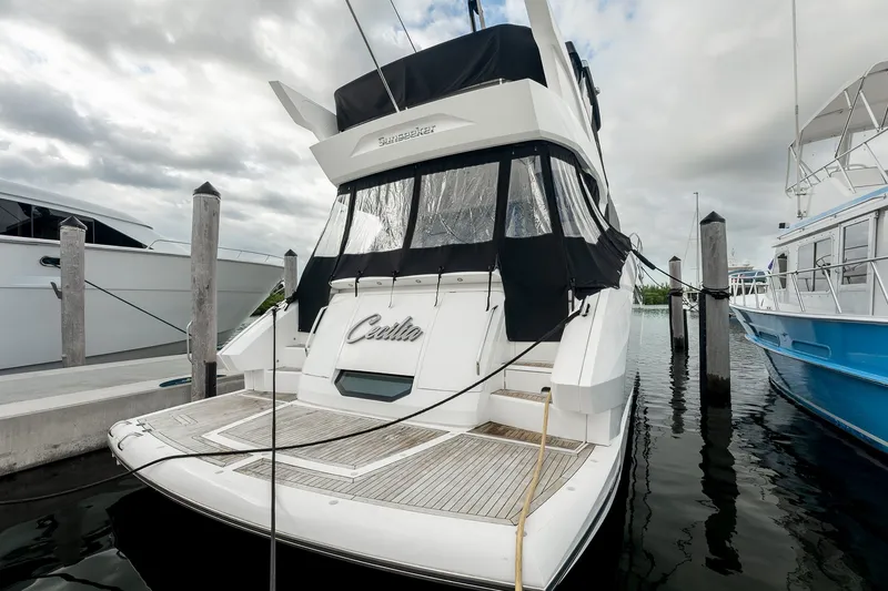 Slide: The Image of 2023 Sunseeker Manhattan 55 yacht docked at marina under cloudy skies. - 16