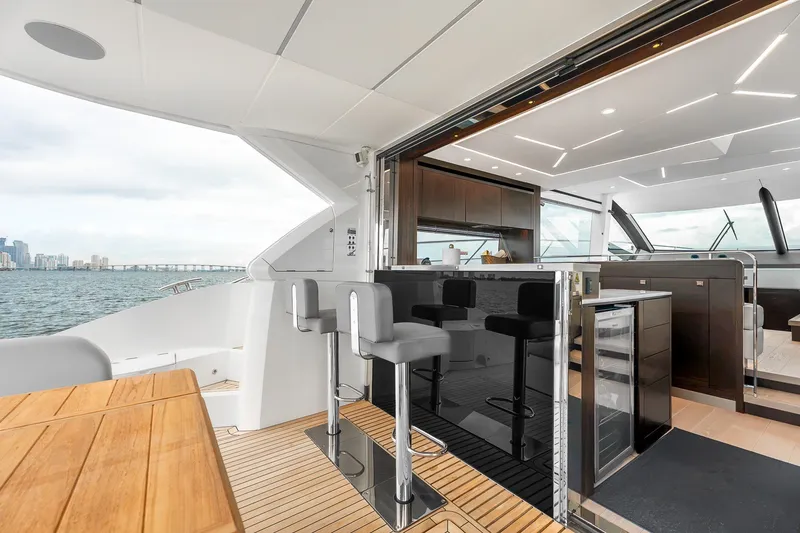 Slide: The Image of Luxurious 2023 Sunseeker Manhattan 55 yacht interior with modern bar and ocean view. - 32