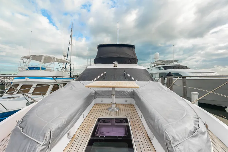 Slide: The Image of 2023 Sunseeker Manhattan 55 yacht deck with table, docked at marina. - 19