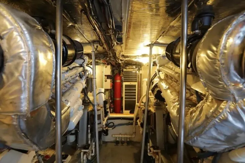 Slide: The Image of Engine room of a 1985 Bertram 54 Convertible yacht, showcasing dual engines. - 27