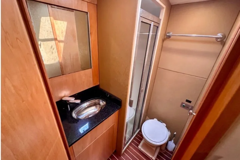 Slide: The Image of Bathroom interior of 1985 Bertram 54 Convertible yacht with sink, toilet, and shower. - 23