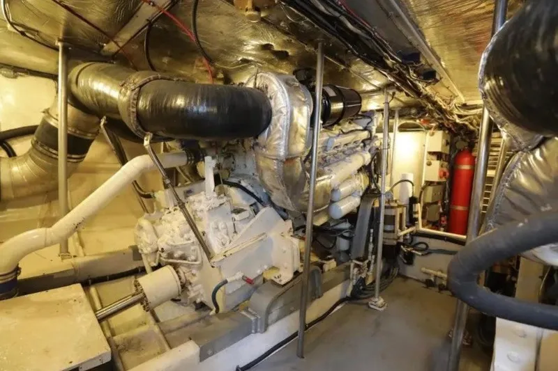 Slide: The Image of Engine room of a 1985 Bertram 54 Convertible yacht, showcasing machinery and equipment. - 24