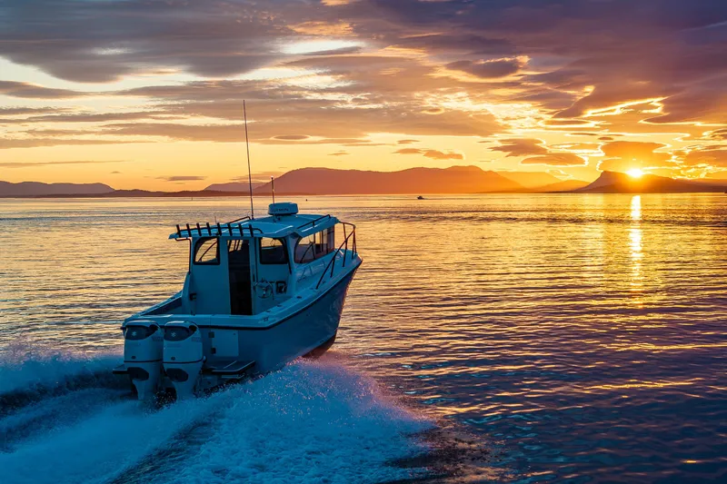 Slide: The Image of Ocean Sport 27 boat cruising at sunset, 2025 model, on tranquil waters. - 23