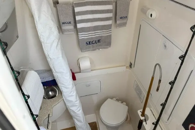 Slide: The Image of Inside console a freshwater head, stainless sink and vanity. The canvas bag has cockpit sunshade with carbon fiber support poles - 12