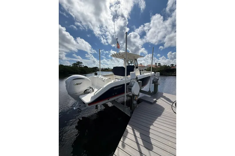 The Image of 2023 Pursuit S 248 Sport boat docked under a cloudy sky. - 0