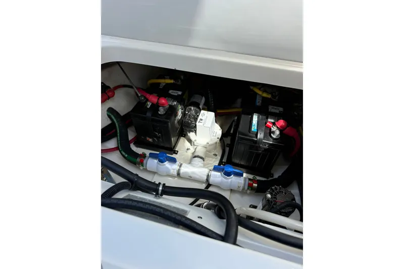 Slide: The Image of 2023 Pursuit S 248 Sport boat battery compartment with wiring and components. - 32
