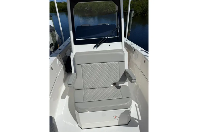 Slide: The Image of 2023 Pursuit S 248 Sport boat seat with gray upholstery and armrests. - 24