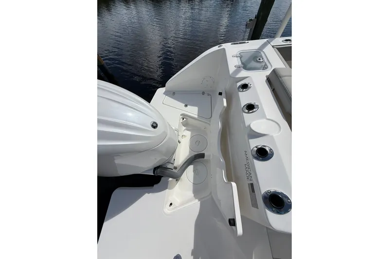 Slide: The Image of 2023 Pursuit S 248 Sport boat deck with motor and rod holders. - 7