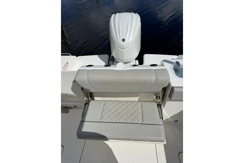 Slide: The Image of 2023 Pursuit S 248 Sport boat with cushioned seating and outboard motor. - 3