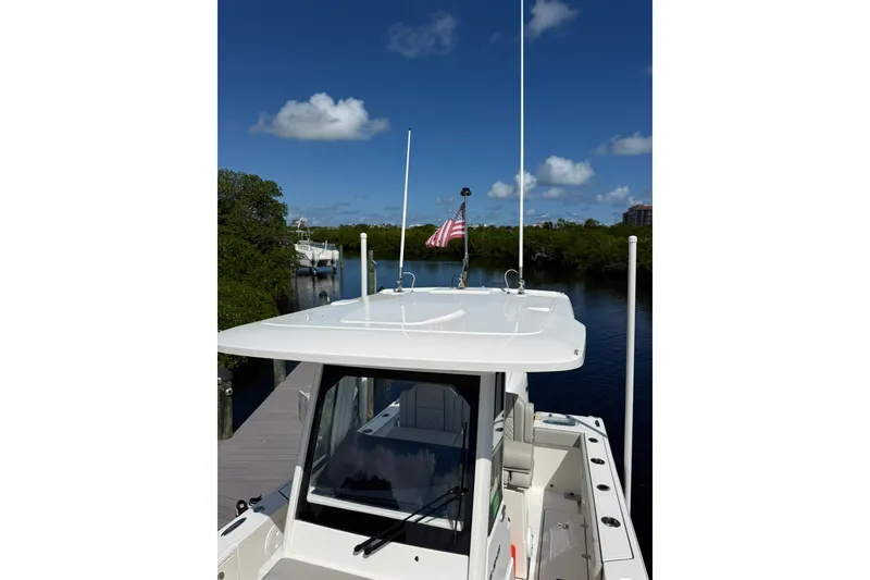 Slide: The Image of 2023 Pursuit S 248 Sport boat docked on a sunny day with clear blue skies. - 25