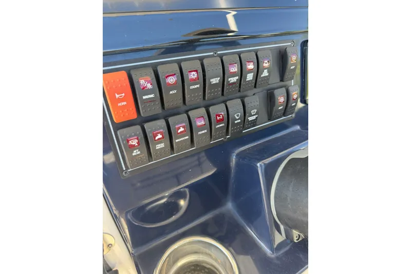 Slide: The Image of Control panel of 2023 Pursuit S 248 Sport boat with labeled switches. - 17