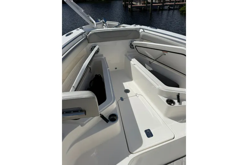 Slide: The Image of 2023 Pursuit S 248 Sport boat interior with open storage compartments. - 21